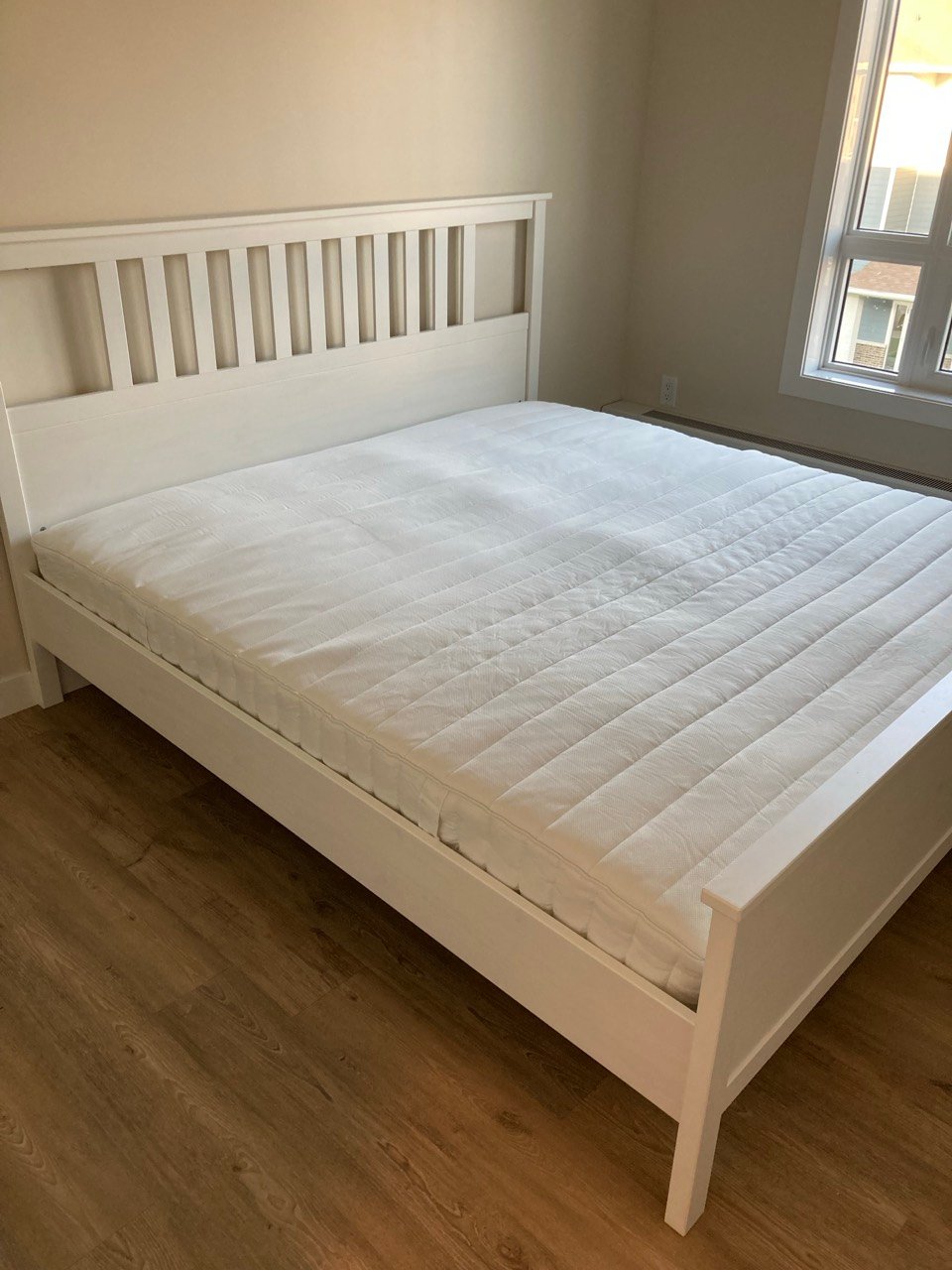 IKEA bed frame assembled in a Regina bedroom
